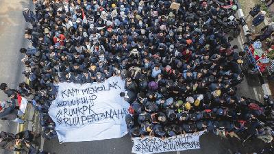 Aksi demonstran membentangkan spanduk menolak RANCANGAN KUHP dan UNDANG-UNDANG KPK yang baru di depan Gedung MPR/DPR, Jakarta, 23 September 2019./ TEMPO/M Taufan Rengganis