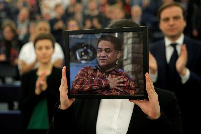 Jewer Ilham putri Ilham Tohti menunjukan foto ayahnya saat berada di Parlemen Uni Eropa di, Starsbourg, Prancis, Desember 2019.  REUTERS/Vincent Kessler