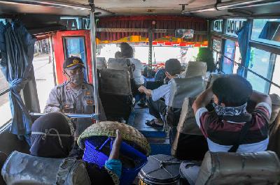 Polisi memeriksa penumpang angkutan umum di Kedungwaringin, Kabupaten Bekasi, Jawa Barat, kemarin.