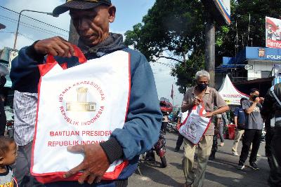 Warga terdampak COVID-19 menerima bantuan sosial dari Presiden Joko Widodo di Terminal Baranangsiang, Kota Bogor, Jawa Barat, 9 April 2020. ANTARA/Arif Firmansyah