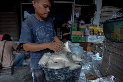 Pedagang membungkus gula pasir kiloan di salah satu agen penjualan sembako kawasan Kebayoran, Jakarta, 14 April 2020. Tempo/Tony Hartawan