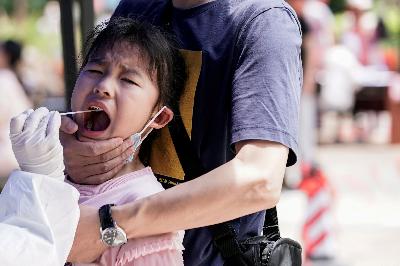 Seorang anak tampak bereaksi saat uji swab asam nukleat di Wuhan, Cina, 16 Mei lalu. Wuhan, ibu kota provinsi Hubei, kota pertama ditemukannya virus corona. REUTERS / Aly Song
