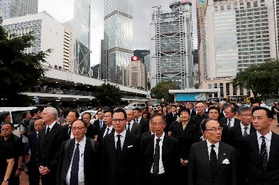 Ribuan profesional hukum mengenakan jas hitam berjalan ke kantor perwakilan pemerintah pusat di Hong Kong, Juni tahun lau. Mereka memprotes menuntut otoritas setempat membatalkan RUU Ekstradisi yang diusulkan Cina di Hong Kong. REUTERS / Tyrone Siu