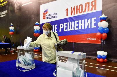 Seorang wanita memasukan kertas suara di tempat pemungutan suara untuk menentukan reformasi konstitusi di Vladivostok, Rusia, 25 Juni 2020. REUTERS / Yuri Maltsev