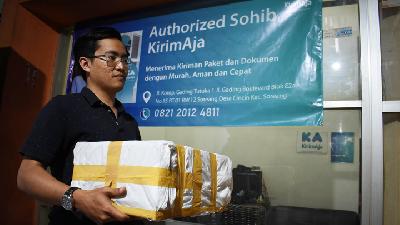 Ramadhani Febriantoro, a partner courier of KirimAja, carrying a package in Soreang, Bandung, West Java, August 28./ TEMPO/Prima Mulia