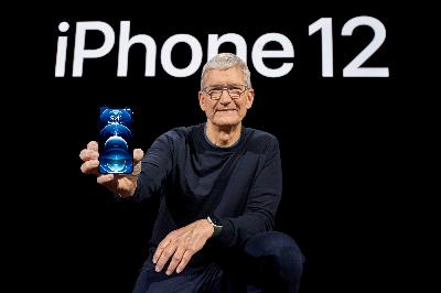 CEO Apple Tim Cook menunjukan  iPhone 12 Pro di Apple Park, Cupertino, California, Amerika Serikat, 13 Oktober 2020.  Brooks Kraft/Apple Inc./Handout via REUTERS