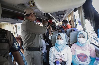 Petugas gabungan melakukan pengecekan di dalam bus pariwisata saat operasi pembatasan kendaraan dan operasi masker di Jalan Raya Puncak, Gadog, Kabupaten Bogor, Jawa Barat, 29 Oktober 2020.   TEMPO/M Taufan Rengganis