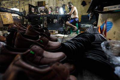 Pengerajin  sepatu kulit tetap memproduksi saat penurunan omset selama pandemi Covid-19 di kawasan Penggilingan, Jakarta, 2 Oktober 2020. Tempo/Tony Hartawan