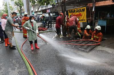 Wali Kota Surabaya Tri Rismaharini membersihkan jalan saat kerja bakti pembersihan saluran air di Mulyosari, Surabaya, Jawa Timur, 12 Desember 2020.  ANTARA/Didik Suhartono