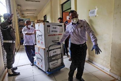 Petugas membawa kotak yang berisi vaksin sinovac di Gudang UPTD Farmasi Kabupaten Bekasi, Tambun, Jawa Barat,  27 Januari 2021. TEMPO / Hilman Fathurrahman W