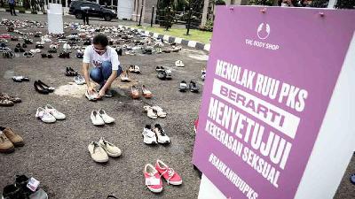 Aktivis meletakkan sepatu dalam aksi diam 500 langkah awal sahkan RUU PKS di depan Gedung DPR RI, Jakarta, November 2020. TEMPO/M Taufan Rengganis