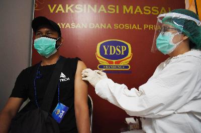 Seorang tenaga pendidik mendapat suntikan vaksin Covid-19 di Bandung, Jawa Barat, 12 April 2021. TEMPO/Prima Mulia