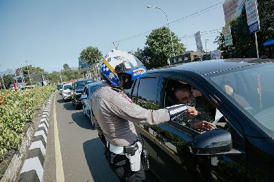 Petugas gabungan memeriksa kelengkapan surat pengemudi di pos penyekatan PPKM Darurat, Simpang Gadog, Bogor, Jawa Barat, 6 Juni 2021.  TEMPO/M Taufan Rengganis