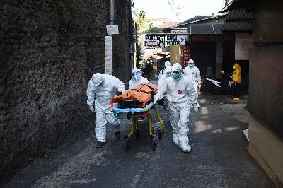 Petugas 119 Dinas Kesehatan dan Puskesmas Sukajadi mengevakuasi jenazah pasien Covid-19 yang melakukan isolasi mandiri di rumahnya, Cibarengkok, Bandung, Jawa Barat, 18 Juli 2021. TEMPO/Prima Mulia