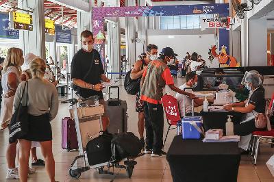 Petugas Satgas Covid-19 mengarahkan warga negara asing penumpang pesawat untuk menjalani tes usap Polymerase Chain Reaction (PCR) di Bandara I Gusti Ngurah Rai, Kuta, Bali, 1 Juli 2021. Johannes P. Christo