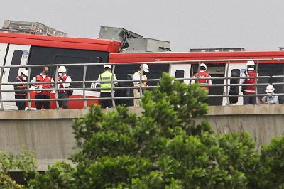 Petugas mengecek kereta Lintas Rel Terpadu (LRT) yang mengalami kecelakaan di Ruas Cibubur-TMII, Jakarta, 25 Oktober 2021. TEMPO / Hilman Fathurrahman W