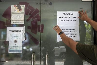 Petugas kantor Kelurahan Gondangdia memasang pengumuman pelayanan sementara ditutup karena sebanyak 33 pegawainya positif COVID-19 di Jakarta, 19 Januari 2022. ANTARA/Muhammad Adimaja
