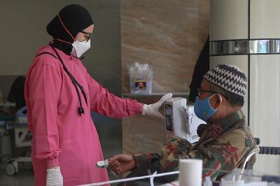 Petugas kesehatan memeriksa pasien Covid-19 di RSUD Chasbullah Abdulmajid, Kota Bekasi, Jawa Barat, 4 Februari 2022. TEMPO/Hilman Fathurrahman W