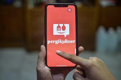 Warga membuka aplikasi Pergikuliner di Jakarta, 8 April 2022. Tempo/Tony Hartawan