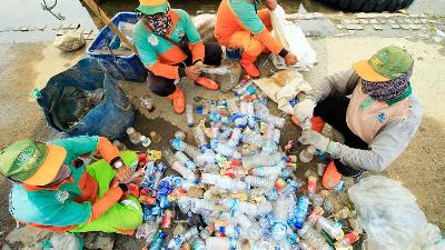 Aktivitas mengumpulkan limbah sampah plastik yang menggenangi air laut di Dermaga Kali Adem, Muara Angke, Jakarta Utara, Oktober 2021/TEMPO/Daniel Christian D.E