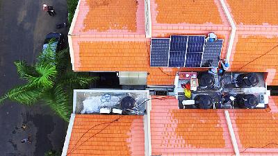 Workers install a solar power generator (PLTS) unit on the roof of a resident’s home in Jimbaran, Bali, in May.
Special Photo
