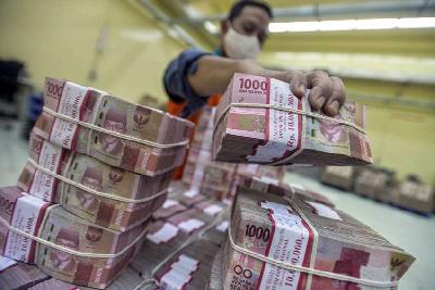 Petugas bank memindahkan tumpukan uang rupiah di sebuah Cash Center Bank di Jakarta. Tempo/Tony Hartawan