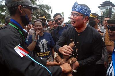 Gubernur Ridwan Kamil diberi oleh-oleh hasil bumi oleh petani saat aksi unjuk rasa Rakyat Tani Nyaba Ka Menak di Bandung, Jawa barat, 26 September 2022. TEMPO/Prima Mulia