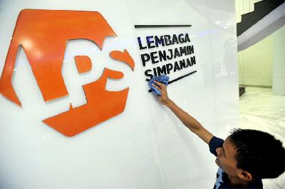 Karyawan membersihkan logo Lembaga Penjamin Simpanan (LPS) di Jakarta. ANTARA/Audy Alwi
