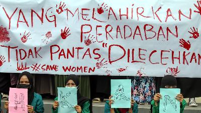 Women’s activists call for an end to sexual violence in Lhokseumawe, Aceh, December 9. The banner reads “Those who give birth to civilization do not deserve to be abused.”
Antara/Rahmad/File Photo
