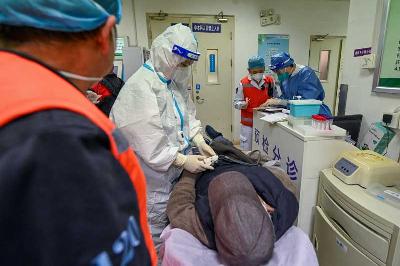 Seorang dokter di pusat penyelamatan darurat Chaoyang menjelaskan kondisi seorang pasien kepada staf rumah sakit di tengah wabah penyakit virus corona di Beijing, Tiongkok, 29 Desember 2022. Reuters/cnsphoto