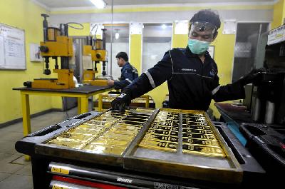 Pekerja menata emas batang di pembuatan emas Antam, Jakarta. TEMPO/Tony Hartawan
