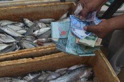 Warga berbelanja ikan menggunakan mata uang rupiah dan ringgit Malaysia di perbatasan Indonesia-Malaysia, Pulau Sebatik. ANTARA/M Rusman

