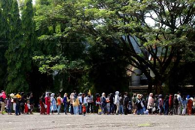Warga antre mengambil bantuan sosial bahan pangan di halaman Monumen Perjuangan Rakyat di Bandung, Jawa Barat, 10 Mei 2023. TEMPO/Prima Mulia
