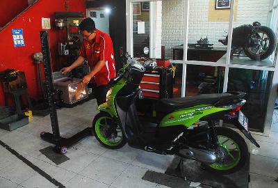 Mekanik memeriksa data sepeda motor yang sudah dikonversi dari mesin bensin ke motor listrik di bengkel konversi binaan BRT electric Bacip Moto Shop di Bandung, Jawa Barat, 3 Juli 2023. TEMPO/Prima mulia