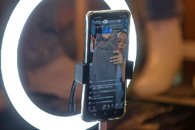 Pedagang melakukan penawaran barang secara daring menggunakan handphone di salah satu kios di Pasar Tanah Abang, Jakarta, 21 September 2023. Tempo/Tony Hartawan