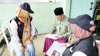 Petugas Pemutakhiran Data Pemilih melakukan coklit data pemilih di Cisalak, Depok, Jawa Barat, 22 Februari 2023. Tempo/M Taufan Rengganis