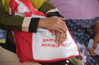 Warga menerima bantuan pangan beras cadangan pangan pemerintah dari Presiden Joko Widodo di Gudang Bulog, Cibitung, Jawa Barat, 16 Februari 2024.  TEMPO/Subekti.