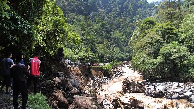 Sejumlah masyarakat melihat kondisi jalan yang amblas di dekat kawasan Lembah Anai, Kabupaten Tanah Datar., Sumatera Barat, 12 Mei 2024/Tempo/Fachri Hamzah